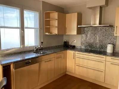 a kitchen with wooden cabinets and a sink at Apartment Seehof by Interhome in Rorschacherberg