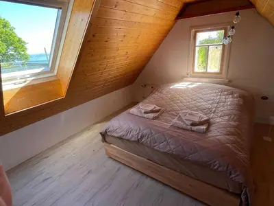 a bedroom with a bed in a room with two windows at Apartment Wartheim by Interhome in Heiden