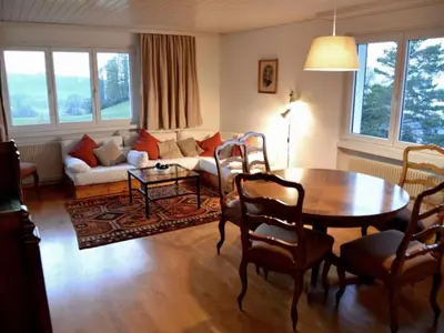 a living room with a table and a couch at Holiday Home See in Sicht by Interhome in Wolfhalden