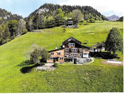 a large house on a hill in a green field at Apartment Gubel by Interhome in Alt Sankt Johann