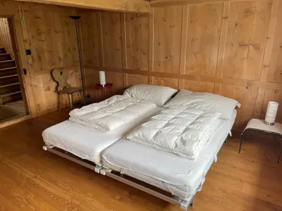 a bed in a room with wooden walls at Holiday Home Bijou in Unterwasser by Interhome in Unterwasser