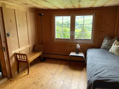 a bedroom with a bed and a window in a room at Holiday Home Bijou in Unterwasser by Interhome in Unterwasser