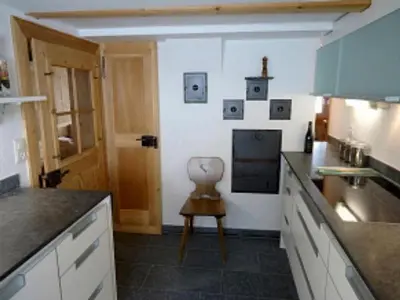 a kitchen with a counter and a chair in it at Holiday Home Bijou in Unterwasser by Interhome in Unterwasser
