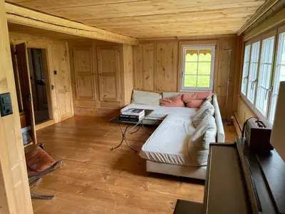 a small room with a couch in a wooden house at Holiday Home Bijou in Unterwasser by Interhome in Unterwasser