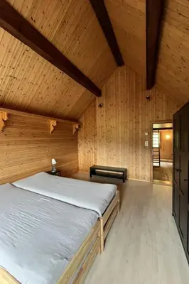 a bedroom with a bed in a wooden room at Apartment Sweet Home by Interhome in Wildhaus