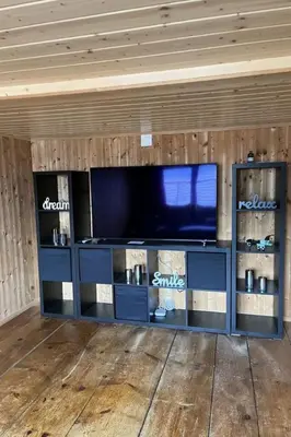 a entertainment center with a flat screen tv in a room at Apartment Sweet Home by Interhome in Wildhaus