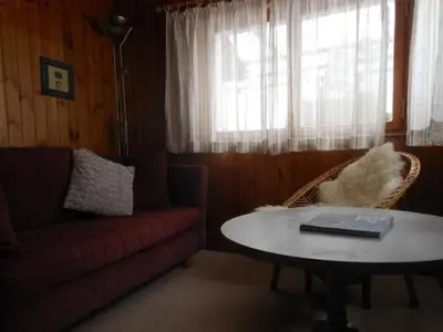 a living room with a couch and a table and a window at Holiday Home MECK-HEI by Interhome in Wildhaus