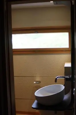 a bathroom with a sink and a window at Holiday Home MECK-HEI by Interhome in Wildhaus
