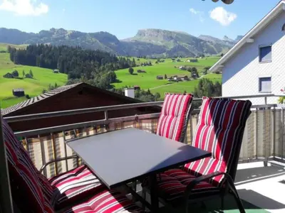 a table and chairs on a balcony with a view at Apartment Studio Friedegg by Interhome in Wildhaus