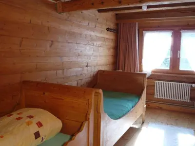 a room with two bunk beds in a log cabin at Holiday Home Appenzell House by Interhome in Thal