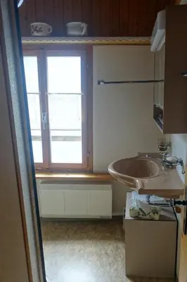 a bathroom with a sink and a window at Holiday Home das schiefe Haus by Interhome in Oberschan