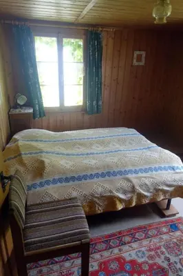 a bedroom with a bed and a window at Holiday Home das schiefe Haus by Interhome in Oberschan