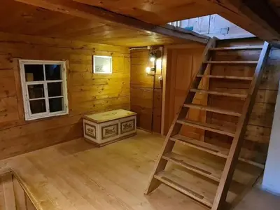 a room with a staircase in a log cabin at Holiday Home Seuzach by Interhome in Nesslau