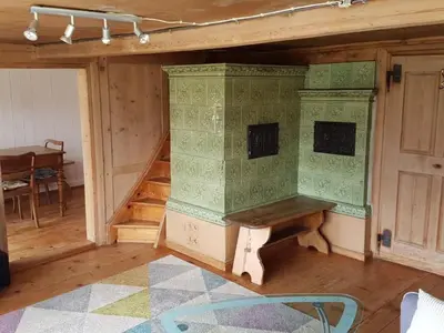 a living room with a table and a staircase at Holiday Home Seuzach by Interhome in Nesslau