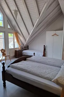a bedroom with two beds and a ceiling with windows at Apartment Zwingli's Ferienwohnung by Interhome in Nesslau