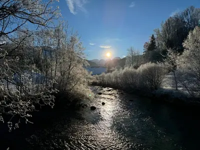 a river with the sun setting in the background at Apartment Zwingli's Ferienwohnung by Interhome in Nesslau