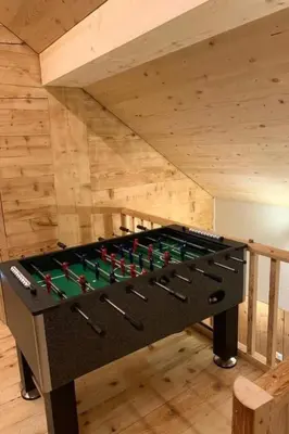 a pool table in a room with a wooden ceiling at Holiday Home Ferienhaus by Interhome in Nesslau