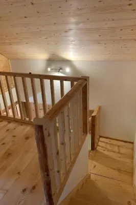 a wooden staircase in a room with wooden floors at Holiday Home Ferienhaus by Interhome in Nesslau