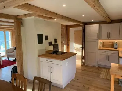 a kitchen with white cabinets and a table in a room at Holiday Home Ferienhaus by Interhome in Nesslau
