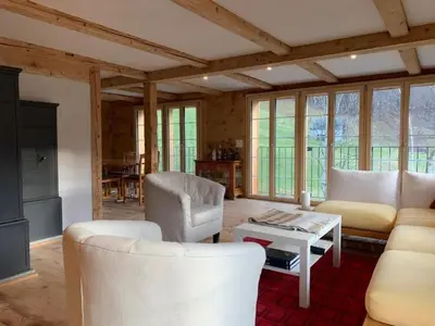 a living room with white furniture and windows at Holiday Home Ferienhaus by Interhome in Nesslau