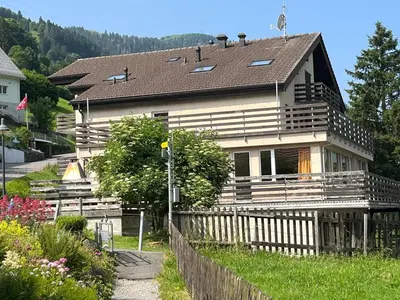 a house with a wooden fence in front of it at Apartment Modern kompakt Speer by Interhome in Alt Sankt Johann