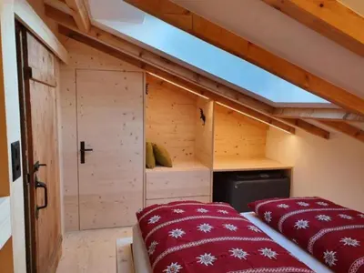 a room with two beds in a small room at Holiday Home Oberguet by Interhome in Unterwasser