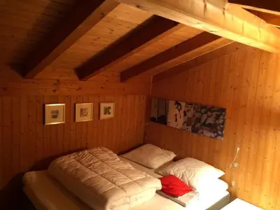 a bedroom with two beds in a wooden room at Holiday Home Höckli by Interhome in Wildhaus