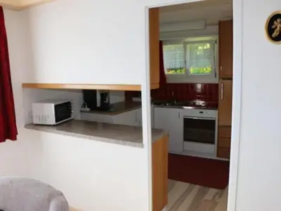 a kitchen with white cabinets and a microwave at Apartment Chalet Lilian by Interhome in Unterwasser
