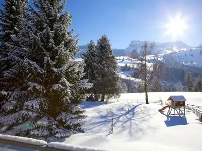 a snow covered slope with trees and a gazebo at Holiday Home Befang 17 by Interhome in Wildhaus