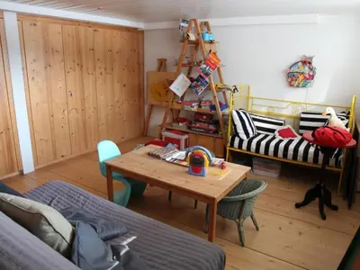 a living room with a table and a couch at Holiday Home Befang 17 by Interhome in Wildhaus