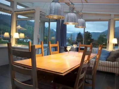 a dining room with a wooden table and chairs at Holiday Home Befang 17 by Interhome in Wildhaus