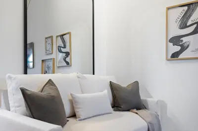 a white couch with pillows in a living room at BLIV Exklusive Dachgeschosswohnung im Zentrum in St. Gallen