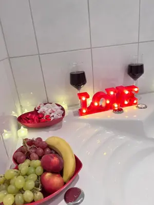 a plate of fruit on a counter with candles and wine glasses at Whirlpool on Lake Constance with free parking in Romanshorn