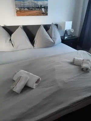 a white bed with two pillows on it at Ferienwohnung Engel in Romanshorn