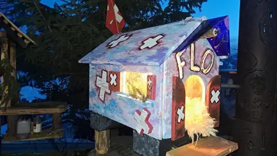 a small gingerbread house with a light on it at toDelete in Nesslau