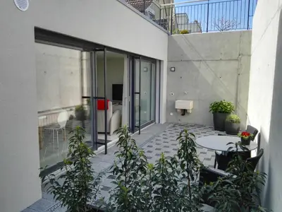 an outdoor patio with a table and some plants at Sunrise Apartment in Staad
