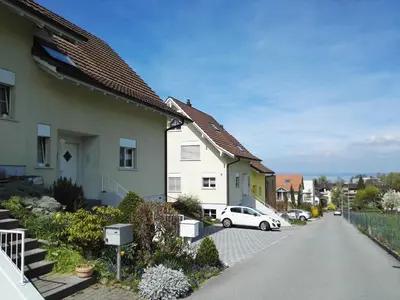 a house with a car parked on a street at Sunrise Apartment in Staad