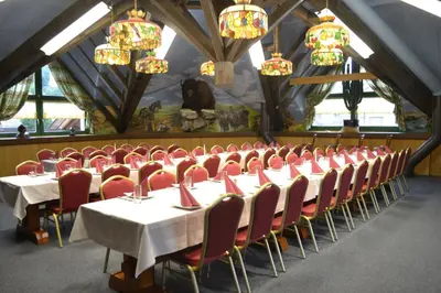 a dining room with tables and chairs and chandeliers at Landgasthof Werdenberg in Werdenberg