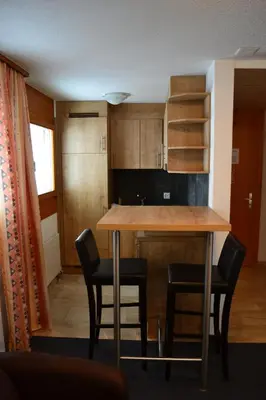 a kitchen with a table and some chairs in a room at Landgasthof Werdenberg in Werdenberg