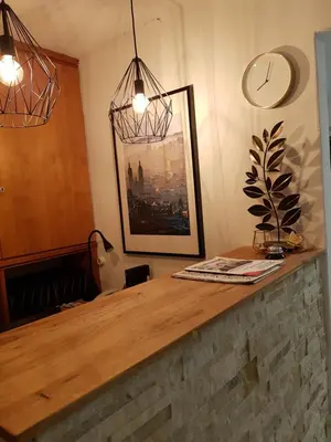 a kitchen with a counter with a clock on the wall at Hotel Elite Self-Check-in in St. Gallen