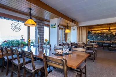 a dining room with a large wooden table and chairs at Berghotel Sellamatt in Alt Sankt Johann