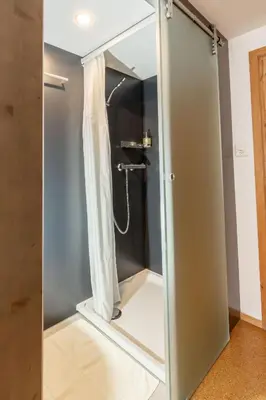 a bathroom with a shower with a glass door at Gasthaus Rössli in Mogelsberg