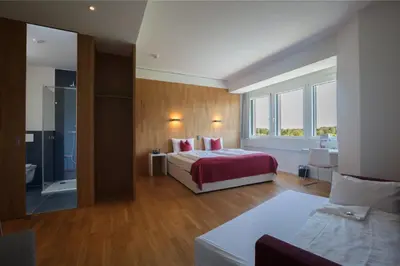 a bedroom with a bed and a large window at Hotel Restaurant Rhy in Oberriet