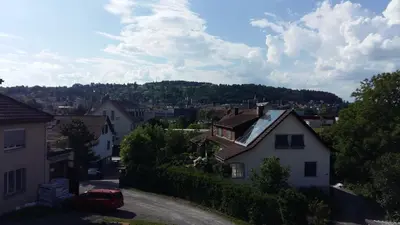 a view of a town with houses and a car at Restaurant Blume in St. Gallen