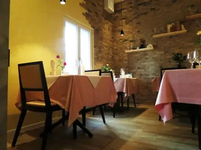 a restaurant with tables and chairs with pink table cloth at Restaurant Blume in St. Gallen