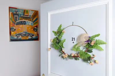 a wreath on a door with a clock on it at Gasthof Zur Traube in Roggwil