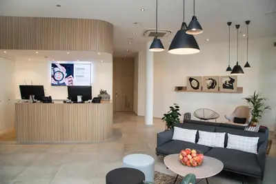 a lobby with a couch and a reception desk at Businesshotel Forum Widnau in Widnau