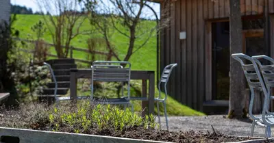 a group of chairs and a table in a yard at Ferienhotel Idyll Gais in Gais
