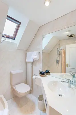 a bathroom with a sink and a toilet and a mirror at Hotel Mozart in Rorschach