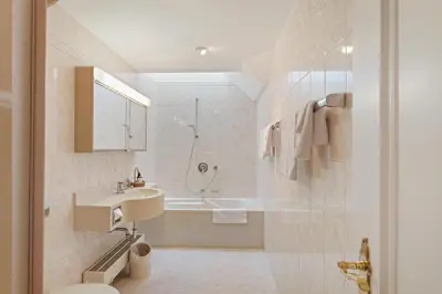 a bathroom with a sink and a bath tub at Hotel Mozart in Rorschach